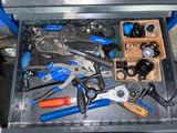 many tools in a tool box on the floor