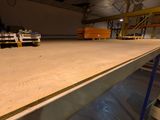 a large wooden table in the middle of a warehouse