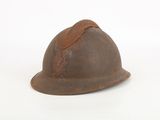 an old rusty helmet on a white surface with a white background