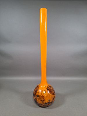 orange glass vase on a gray background with a gray background