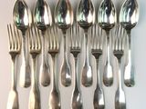 a lot of silver spoons and forks on a table
