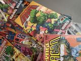 a pile of comic books sitting on a table