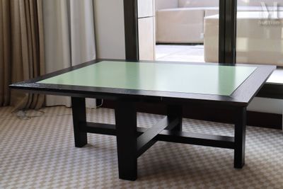 a table with a glass top in front of a window
