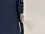 a black purse with a chain hanging from it ' s side