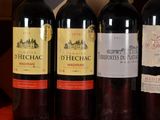 several bottles of wine are lined up in a row on a table