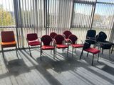 a room with a lot of chairs and a table in it