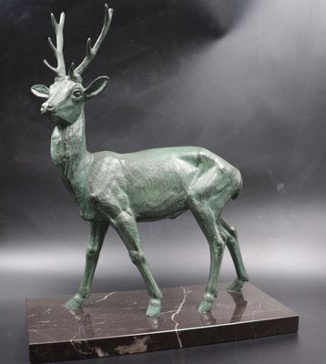 a bronze sculpture of a deer on a marble base