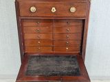 an antique chest of drawers with a marble top and brass hardware