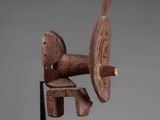 an image of a wooden sculpture of a horse on a stand
