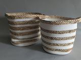 two white and brown striped baskets with handles on a gray background