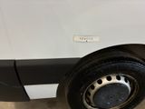 a close up of a tire on the side of a white van