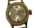 une image représentant une montre en or avec un cadran blanc