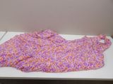 a purple and orange blanket sitting on a white table