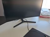 a computer monitor sitting on a desk with a mouse