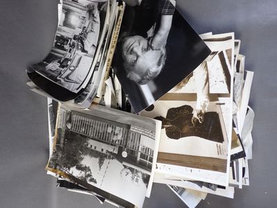 a pile of old black and white photos on a table