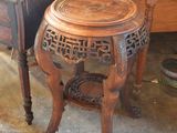 a small table with a wooden top next to a small table with a wooden top