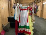 a lot of clothes hanging on a rack in a room