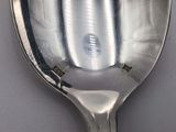 a silver spoon with a silver handle on a table