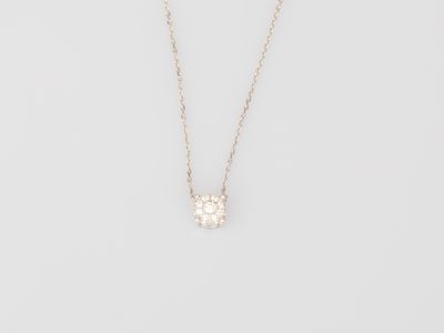 a white diamond flower pendant on a gold chain