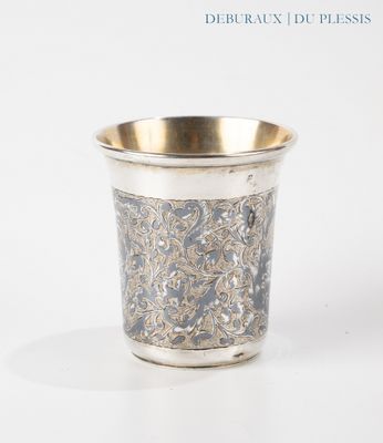 a silver cup that is sitting on a table