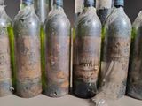 bottles of wine are lined up in a row on a table