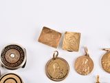 a lot of gold and silver jewelry on a white surface