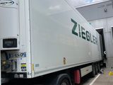 a white semi truck parked in a parking lot