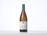 a bottle of white wine sitting on top of a table