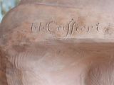a close up of a sculpture of a man ' s torso