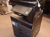 a printer that is sitting on top of a pile of paper