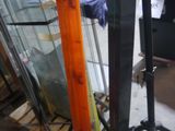 two skis that are sitting on a tripod in a room