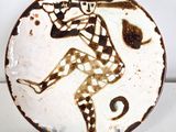 a brown and white plate with a picture of a man on it