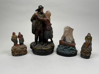 several figurines of a man and a woman on a boat