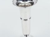 a silver vase that is sitting on a table