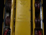 a close up of a yellow toy truck with red wheels