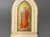 an ornately painted statue of a woman in a red dress