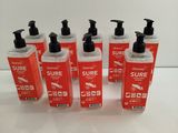 six bottles of hand sanitizer on a white surface