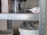 a shelf that has various kitchen items on it