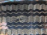 a close up of a silver plate with wavy designs on it