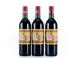 three bottles of red wine sitting next to each other on a white surface