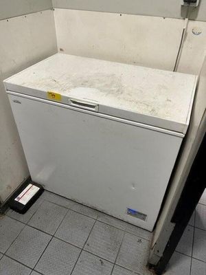 an image of a dirty refrigerator in a dirty bathroom