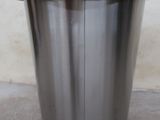 a metal planter that is sitting on the floor