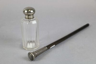a small glass bottle with a metal cap next to a small glass bottle with a metal cap
