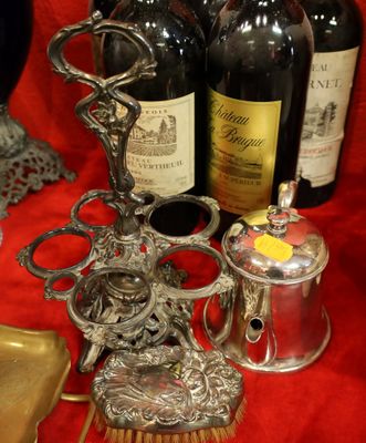 bottles of wine, a brush and a bottle of wine on a table