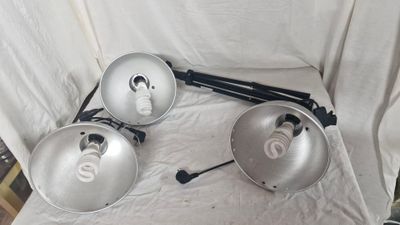 three lights that are sitting on a chair