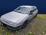 a silver car that is parked on the side of the road