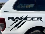 a white truck with a sticker that says ranger on it