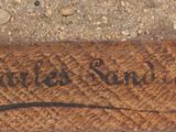 a close up of a piece of wood with writing on it