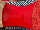 pair of women ' s red and blue shoes on a white surface