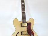 an electric guitar sitting on top of a stand on a white surface